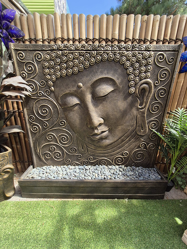 tall Buddha face water feature